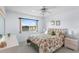 Comfortable bedroom showcasing a lake view, queen-size bed, ceiling fan, and dresser with matching nightstands at 25100 Sandhill Blvd # R202, Punta Gorda, FL 33983