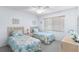 Bright bedroom featuring two twin beds, natural light, and neutral color palette at 25100 Sandhill Blvd # R202, Punta Gorda, FL 33983