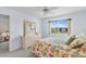 A sunny bedroom featuring water view, floral bedding, and light colored furniture at 25100 Sandhill Blvd # R202, Punta Gorda, FL 33983