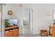 Hallway leading to bedroom showing neutral paint and trim with a wood media center and shelf clock at 25100 Sandhill Blvd # R202, Punta Gorda, FL 33983