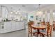 Open kitchen and dining area with white cabinets, black countertops, and modern appliances at 25100 Sandhill Blvd # R202, Punta Gorda, FL 33983
