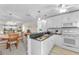 Bright kitchen with white cabinets, granite countertops, and an open view to the dining and living areas at 25100 Sandhill Blvd # R202, Punta Gorda, FL 33983