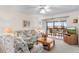 Living room with sliding doors to lanai and views of the outside at 25100 Sandhill Blvd # R202, Punta Gorda, FL 33983