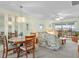 Cozy living room and dining area with large windows and sliding doors leading to the lanai at 25100 Sandhill Blvd # R202, Punta Gorda, FL 33983