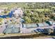 Scenic aerial view of tennis courts in a canal-front community with a pool and boat slips at 25188 Marion Ave # A206, Punta Gorda, FL 33950
