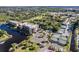 Aerial view of the community, showcasing the tennis courts, pool, and lush landscaping near the waterfront at 25188 Marion Ave # A206, Punta Gorda, FL 33950
