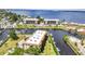 Aerial view of canal-front condos with maintained lawns and boating access at 25188 Marion Ave # A206, Punta Gorda, FL 33950