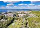 Community aerial view showing tennis courts, a pool, and nearby waterfront views at 25188 Marion Ave # A206, Punta Gorda, FL 33950