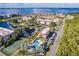 Aerial shot showing a waterfront community with tennis courts, a pool, and beautiful views at 25188 Marion Ave # A206, Punta Gorda, FL 33950