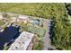 Aerial shot featuring tennis courts, a pool, and boat docks with a canal at 25188 Marion Ave # A206, Punta Gorda, FL 33950