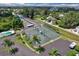 Aerial shot of community tennis courts and surrounding lush landscaping, emphasizing an active lifestyle at 25188 Marion Ave # A206, Punta Gorda, FL 33950