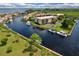Aerial view showcasing waterfront condos with boat docks, creating a luxurious and relaxing waterside living experience at 25188 Marion Ave # A206, Punta Gorda, FL 33950