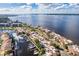 Aerial view of waterfront community featuring lush landscaping, boat docks, and stunning water views at 25188 Marion Ave # A206, Punta Gorda, FL 33950