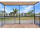 Balcony view overlooking manicured landscaping and neighboring buildings on a sunny day at 25188 Marion Ave # A206, Punta Gorda, FL 33950