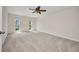 Spacious carpeted bedroom, featuring a ceiling fan and two windows at 25188 Marion Ave # A206, Punta Gorda, FL 33950