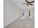Spacious carpeted bedroom, featuring a ceiling fan and two windows at 25188 Marion Ave # A206, Punta Gorda, FL 33950