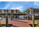 View of boat dock overlooking waterfront condos and picturesque waterway at 25188 Marion Ave # A206, Punta Gorda, FL 33950