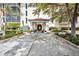 Inviting covered building entrance with landscaped surroundings and lovely plantings at 25188 Marion Ave # A206, Punta Gorda, FL 33950