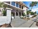 Building entrance featuring stylish glass doors, manicured landscaping, and elegant architectural details at 25188 Marion Ave # A206, Punta Gorda, FL 33950