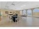Spacious event room with tables, chairs, and abundant natural light perfect for community gatherings at 25188 Marion Ave # A206, Punta Gorda, FL 33950
