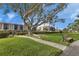Expansive, well-maintained grounds with mature trees, a bench, and condo views at 25188 Marion Ave # A206, Punta Gorda, FL 33950