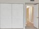Hallway leading to bath, with double bi-fold closet at 25188 Marion Ave # A206, Punta Gorda, FL 33950