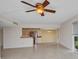 Open-concept living room with tile floors and views to kitchen and dining at 25188 Marion Ave # A206, Punta Gorda, FL 33950