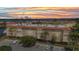 Sunset view of condo complex highlighting its waterfront location, balconies, and parking area at 25188 Marion Ave # A206, Punta Gorda, FL 33950