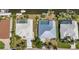 Rooftop view of backyard swimming pools surrounded by lush lawns and tropical landscaping at 2718 Saint Thomas Dr, Punta Gorda, FL 33950