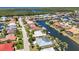 Residential waterfront community featuring diverse architecture, lush landscapes, and private boat docks along winding canals at 2718 Saint Thomas Dr, Punta Gorda, FL 33950