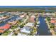 Waterfront living with canal access, docks, and boats, surrounded by lush green spaces in a residential community at 2718 Saint Thomas Dr, Punta Gorda, FL 33950