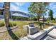 Landscaped backyard showing the lush grass, manicured shrubbery, and a screened in enclosure at 2718 Saint Thomas Dr, Punta Gorda, FL 33950