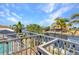 Enjoy serene canal views from the balcony of this waterfront home with tropical landscaping and bright blue skies at 2718 Saint Thomas Dr, Punta Gorda, FL 33950