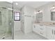 Contemporary bathroom boasts marble shower, sleek vanity, and stylish fixtures for a modern feel at 2718 Saint Thomas Dr, Punta Gorda, FL 33950