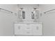Elegant bathroom featuring double sinks, custom cabinetry, and modern light fixtures for a spa-like experience at 2718 Saint Thomas Dr, Punta Gorda, FL 33950
