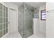 Modern bathroom featuring glass shower with rainfall showerhead and neutral-toned tile and flooring at 2718 Saint Thomas Dr, Punta Gorda, FL 33950