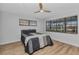 Cozy bedroom features a modern ceiling fan, wood flooring, and plenty of natural light through large windows at 2718 Saint Thomas Dr, Punta Gorda, FL 33950
