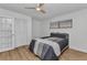 Bright bedroom with a ceiling fan, wood-look floors, and large closet features for ample storage at 2718 Saint Thomas Dr, Punta Gorda, FL 33950