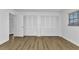 Bright bedroom with wood-look laminate flooring, large closet doors, and ample natural light at 2718 Saint Thomas Dr, Punta Gorda, FL 33950