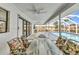 Relaxing screened-in lanai features outdoor dining space with views of the private pool and lush backyard at 2718 Saint Thomas Dr, Punta Gorda, FL 33950