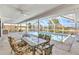 Inviting covered patio with outdoor dining area, overlooking a sparkling blue swimming pool and picturesque canal at 2718 Saint Thomas Dr, Punta Gorda, FL 33950