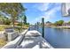 A concrete dock on a tranquil canal offers direct access to waterways, surrounded by lush landscaping at 2718 Saint Thomas Dr, Punta Gorda, FL 33950