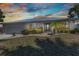 Charming single-story home boasts a well-manicured lawn, metal roof, and a lovely front yard with mature landscaping at 2718 Saint Thomas Dr, Punta Gorda, FL 33950