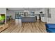 Island kitchen with white cabinetry, stainless appliances, pendant lighting, and a view of the screened-in pool at 2718 Saint Thomas Dr, Punta Gorda, FL 33950