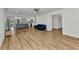 Open-concept living room with wood-look floors seamlessly connects to the kitchen, dining area, and outdoor pool at 2718 Saint Thomas Dr, Punta Gorda, FL 33950