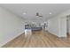 Bright, open-concept living area features wood floors, recessed lighting, and a view of the screened in lanai and kitchen at 2718 Saint Thomas Dr, Punta Gorda, FL 33950