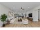 Open-concept living space with modern furnishings, hardwood floors, and seamless access to the kitchen and outdoor area at 2718 Saint Thomas Dr, Punta Gorda, FL 33950