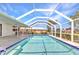 Inviting screened-in pool offers a refreshing escape with clear blue water, adjacent to a patio for lounging at 2718 Saint Thomas Dr, Punta Gorda, FL 33950