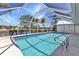 Enjoy an inviting screened pool and patio area surrounded by lush landscaping, with views of the adjacent canal at 2718 Saint Thomas Dr, Punta Gorda, FL 33950