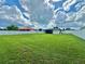 Expansive, lush backyard with a privacy fence, offering ample space for outdoor activities and entertaining at 3324 Port Charlotte Blvd, Port Charlotte, FL 33952